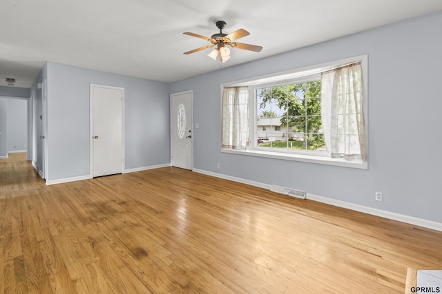 1309 Hansen Ave, Bellevue, NE 68005 - unfurnished living room featuring a ceiling fan and wood finished floors