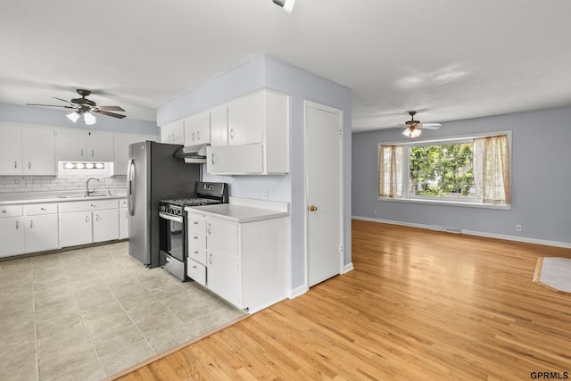 1309 Hansen Ave, Bellevue, NE 68005 - kitchen with appliances with stainless steel finishes, a ceiling fan, under cabinet range hood, and light countertops