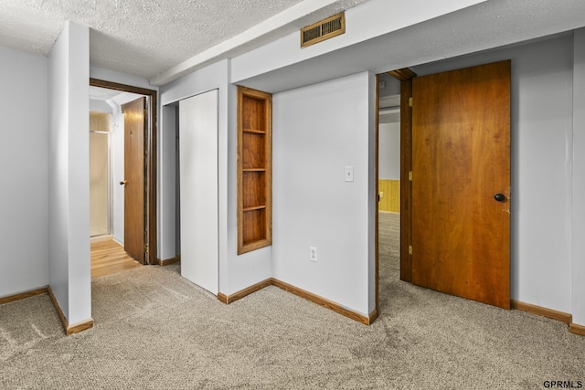 1309 Hansen Ave, Bellevue, NE 68005 - unfurnished bedroom featuring carpet floors, a textured ceiling, and a closet