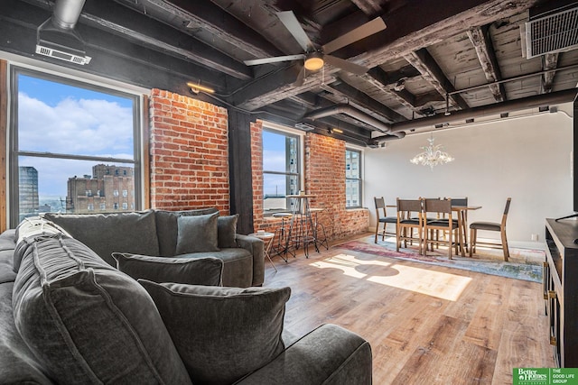 312 S 16th St Unit 904, Omaha, NE 68102 - living area featuring ceiling fan, wood finished floors, a chandelier, and brick wall