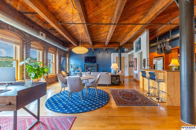 105 S 9th St Unit 308, Omaha, NE 68102 - dining area with a wood ceiling with exposed beams, ornate columns, wood finished floors, and a glass covered fireplace