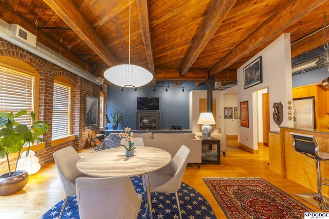 105 S 9th St Unit 308, Omaha, NE 68102 - dining space with light wood finished floors, a wood ceiling with exposed beams, and brick wall