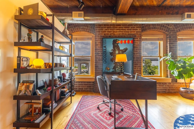 105 S 9th St Unit 308, Omaha, NE 68102 - office space featuring a wood ceiling with exposed beams, wood-type flooring, and brick wall