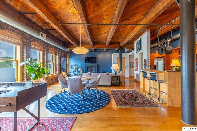105 S 9th St Unit 308, Omaha, NE 68102 - dining area with a wood ceiling with exposed beams, ornate columns, wood finished floors, and a glass covered fireplace