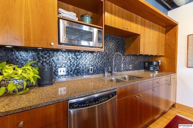105 S 9th St Unit 308, Omaha, NE 68102 - kitchen featuring appliances with stainless steel finishes, dark stone counters, light wood-style flooring, and decorative backsplash