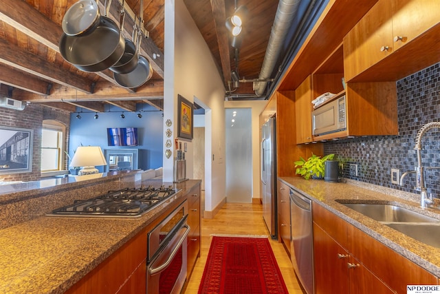 105 S 9th St Unit 308, Omaha, NE 68102 - kitchen with appliances with stainless steel finishes, light wood-style floors, open shelves, decorative backsplash, and brown cabinetry