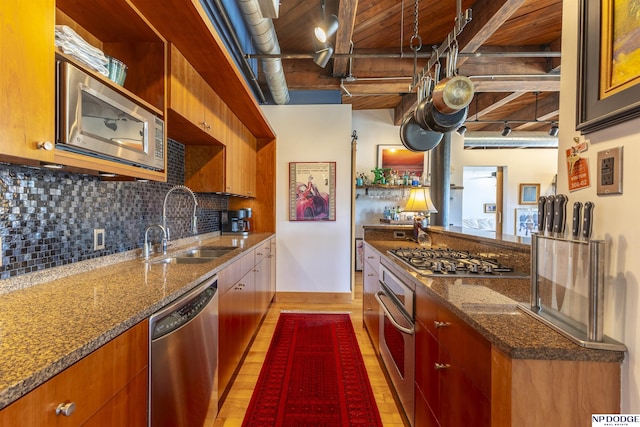 105 S 9th St Unit 308, Omaha, NE 68102 - kitchen with stainless steel appliances, a wood ceiling with exposed beams, decorative backsplash, light wood-type flooring, and dark stone counters
