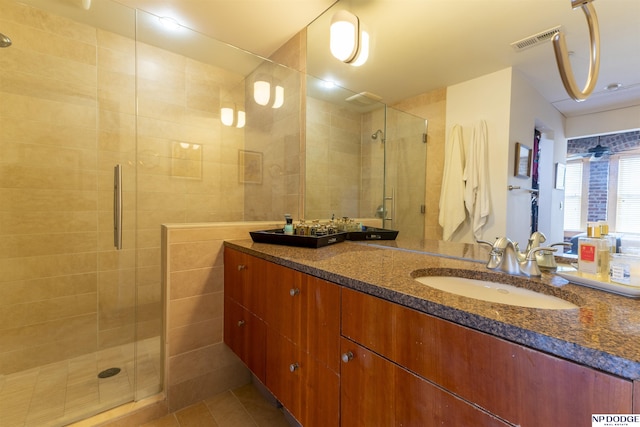 105 S 9th St Unit 308, Omaha, NE 68102 - bathroom featuring a stall shower, vanity, and tile patterned floors