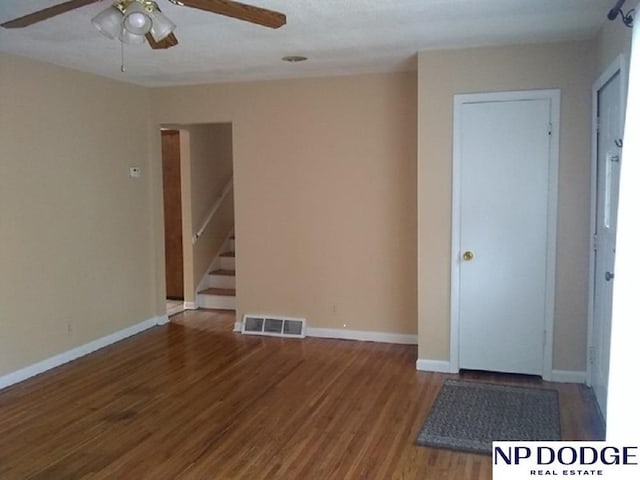 4501 S 48th St, Lincoln, NE 68516 - unfurnished room featuring ceiling fan, wood finished floors, and stairs