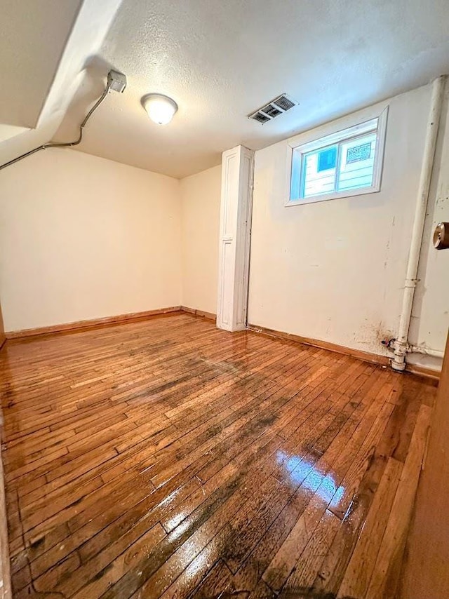 623 S 33rd St, Omaha, NE 68105 - below grade area with hardwood / wood-style flooring and a textured ceiling