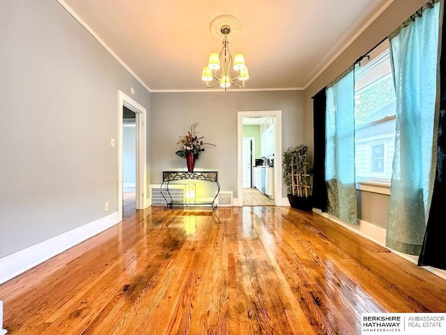 623 S 33rd St, Omaha, NE 68105 - dining area with a chandelier, hardwood / wood-style floors, and crown molding