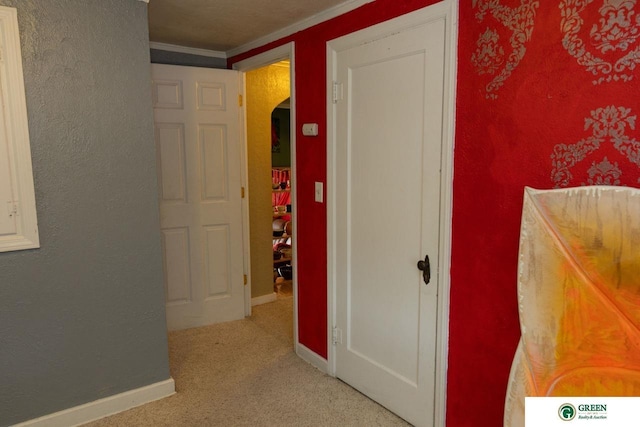 503 E 12th St, York, NE 68467 - hallway with arched walkways, light carpet, and crown molding
