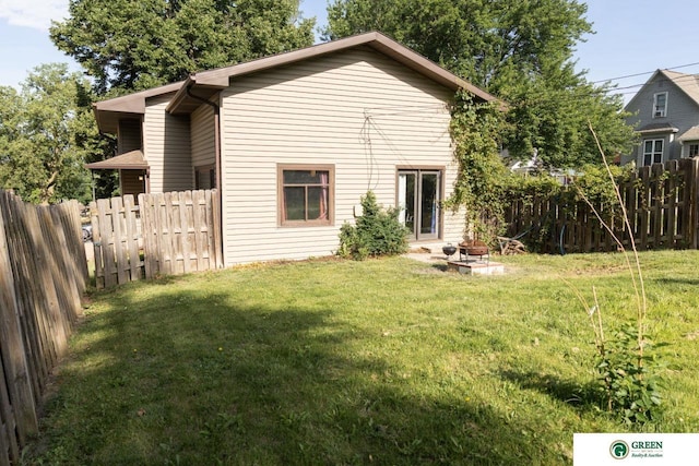 503 E 12th St, York, NE 68467 - back of house with a fenced backyard and a fire pit