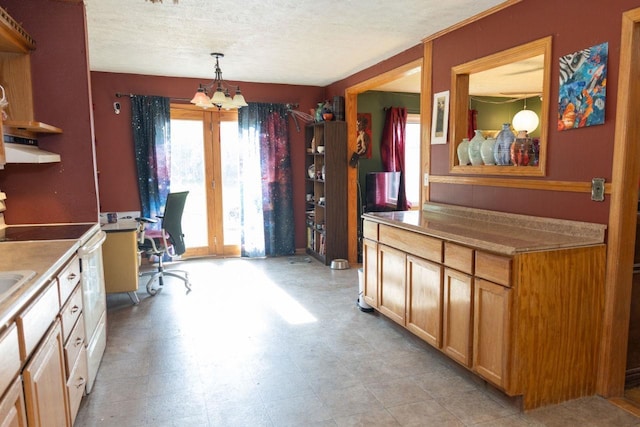 503 E 12th St, York, NE 68467 - kitchen with white range with electric cooktop, a chandelier, a desk, a textured ceiling, and light countertops