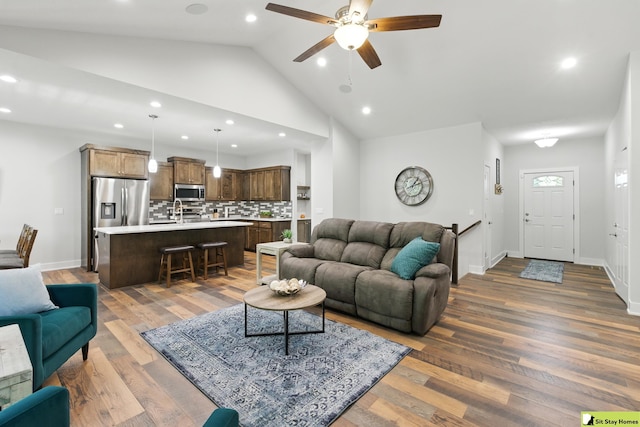 15436 Fowler Ave, Omaha, NE 68116 - living room featuring recessed lighting, vaulted ceiling, ceiling fan, and wood finished floors