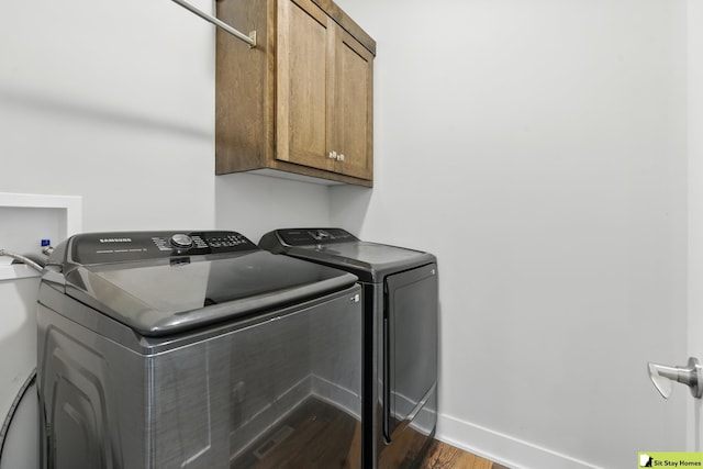 15436 Fowler Ave, Omaha, NE 68116 - laundry room featuring cabinet space, independent washer and dryer, and wood finished floors