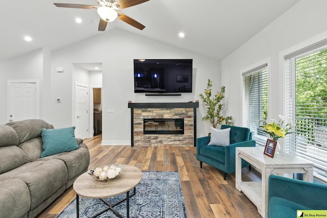 15436 Fowler Ave, Omaha, NE 68116 - living area with ceiling fan, vaulted ceiling, wood finished floors, a stone fireplace, and recessed lighting