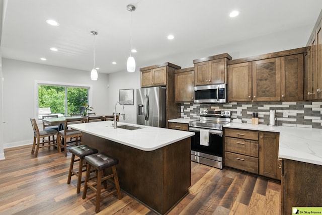 15436 Fowler Ave, Omaha, NE 68116 - kitchen with stainless steel appliances, decorative backsplash, recessed lighting, and dark wood-style flooring