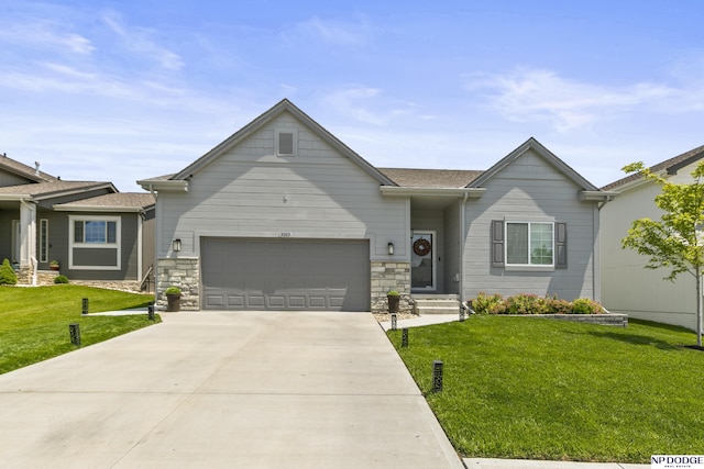 5003 N 180th Ave, Elkhorn, NE 68022 - view of front of property with driveway, a garage, a front yard, and stone siding