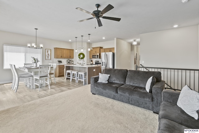 5003 N 180th Ave, Elkhorn, NE 68022 - living room featuring ceiling fan, a chandelier, light wood-type flooring, and recessed lighting