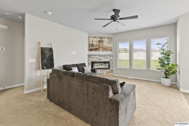 5003 N 180th Ave, Elkhorn, NE 68022 - living area with light colored carpet, a stone fireplace, and ceiling fan