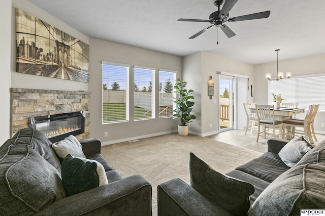 5003 N 180th Ave, Elkhorn, NE 68022 - living area with a chandelier, a fireplace, carpet, and a ceiling fan
