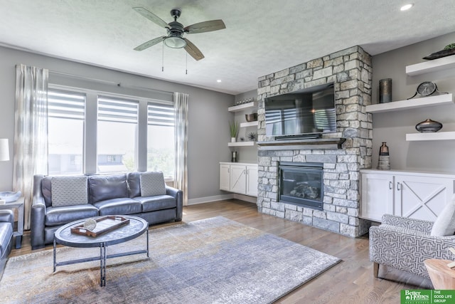 20761 Shirley St, Omaha, NE 68022 - living area with wood finished floors, ceiling fan, a fireplace, a textured ceiling, and recessed lighting