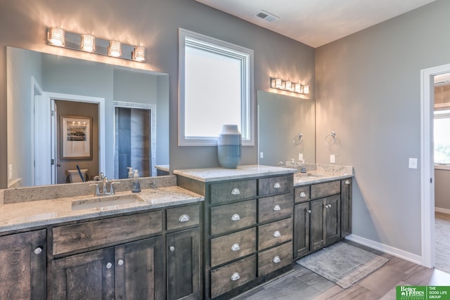 20761 Shirley St, Omaha, NE 68022 - full bathroom with double vanity and wood finished floors