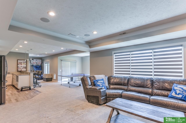 20761 Shirley St, Omaha, NE 68022 - living room featuring light carpet, recessed lighting, a textured ceiling, and a raised ceiling