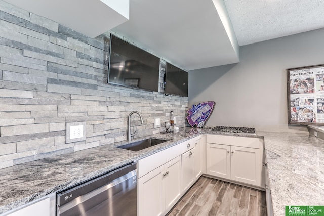 20761 Shirley St, Omaha, NE 68022 - kitchen with stainless steel appliances, white cabinetry, light stone countertops, a textured ceiling, and decorative backsplash