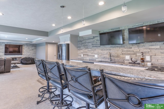 20761 Shirley St, Omaha, NE 68022 - indoor wet bar with stainless steel fridge with ice dispenser, recessed lighting, a textured ceiling, pendant lighting, and light colored carpet