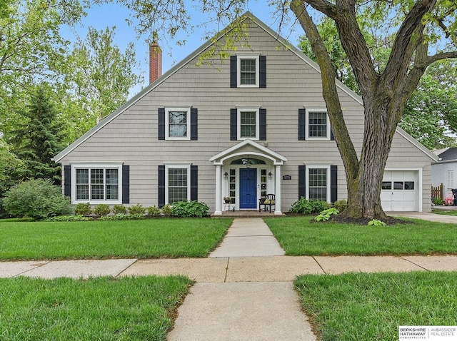 5119 Hamilton St, Omaha, NE 68132 - view of front of home with a chimney, an attached garage, and a front yard