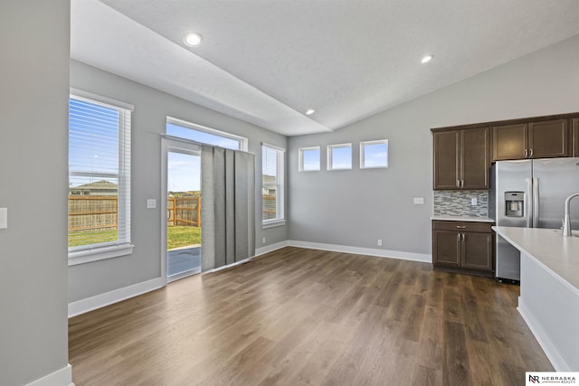 7530 Augustine Ave, Lincoln, NE 68516 - kitchen featuring stainless steel fridge, light countertops, tasteful backsplash, dark wood finished floors, and dark brown cabinets