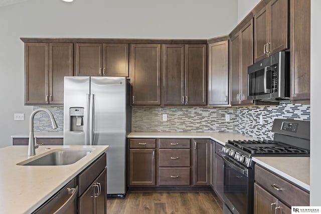 7530 Augustine Ave, Lincoln, NE 68516 - kitchen featuring appliances with stainless steel finishes, dark brown cabinets, and dark wood finished floors