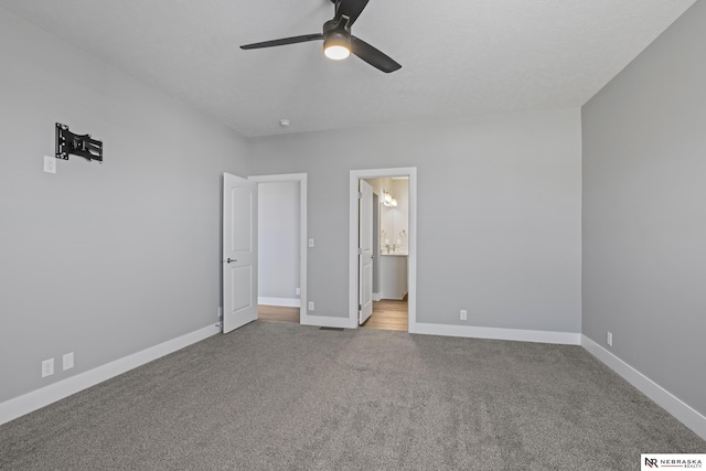 7530 Augustine Ave, Lincoln, NE 68516 - unfurnished bedroom featuring carpet, a ceiling fan, and ensuite bath