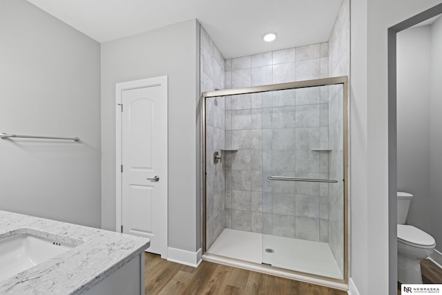 7530 Augustine Ave, Lincoln, NE 68516 - full bathroom featuring a stall shower, vanity, and wood finished floors