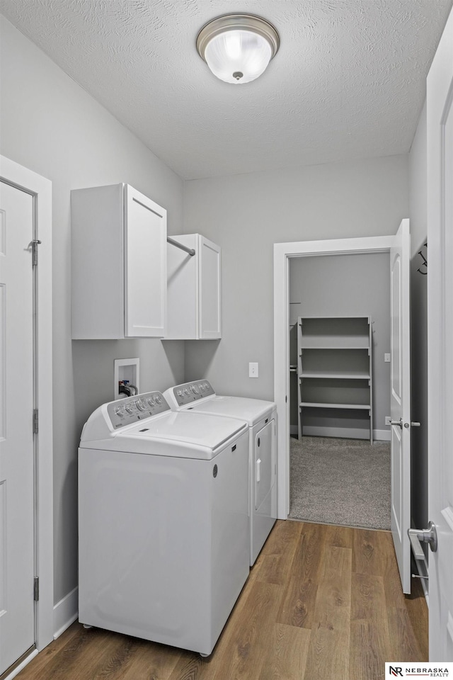 7530 Augustine Ave, Lincoln, NE 68516 - laundry area with cabinet space, separate washer and dryer, dark wood-style flooring, and a textured ceiling