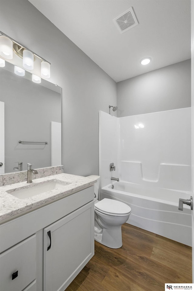 7530 Augustine Ave, Lincoln, NE 68516 - bathroom with vanity, washtub / shower combination, and wood finished floors