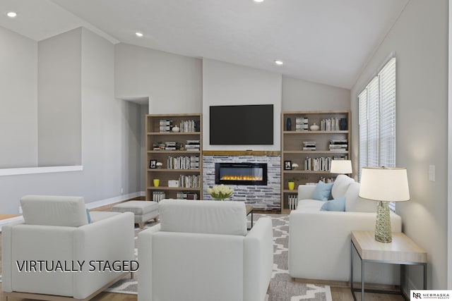 7530 Augustine Ave, Lincoln, NE 68516 - living room featuring lofted ceiling, a glass covered fireplace, wood finished floors, recessed lighting, and built in features