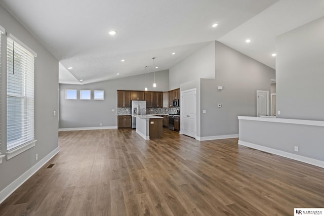 7530 Augustine Ave, Lincoln, NE 68516 - unfurnished living room with dark wood-type flooring, recessed lighting, and high vaulted ceiling