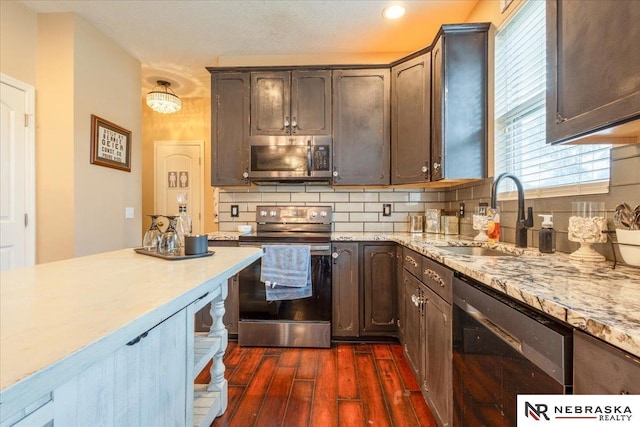 16228 Virginia St, Omaha, NE 68136 - kitchen featuring stainless steel appliances, dark wood-type flooring, tasteful backsplash, dark brown cabinetry, and light stone countertops