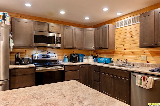 817 S 3rd St, Nebraska City, NE 68410 - kitchen featuring appliances with stainless steel finishes, recessed lighting, light countertops, and wooden walls