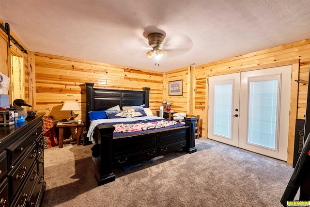 817 S 3rd St, Nebraska City, NE 68410 - bedroom featuring carpet floors, wooden walls, french doors, and a textured ceiling