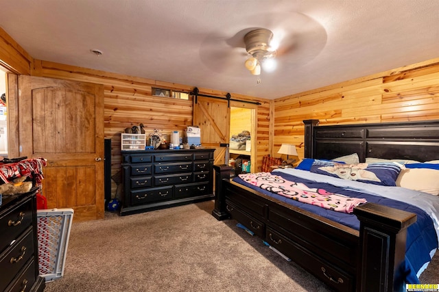 817 S 3rd St, Nebraska City, NE 68410 - bedroom with carpet, wood walls, a barn door, and a ceiling fan