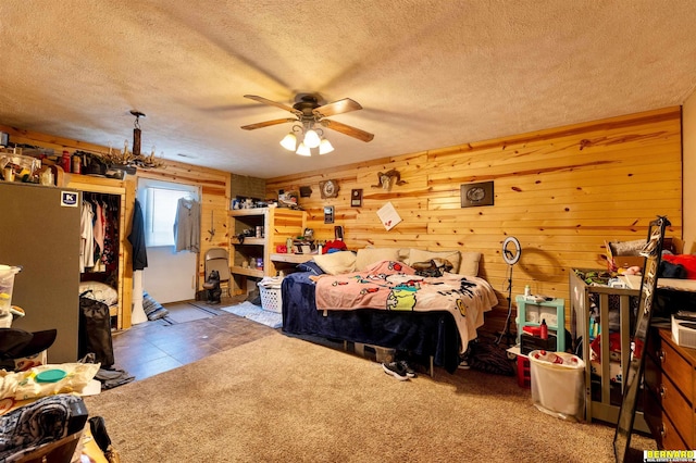 817 S 3rd St, Nebraska City, NE 68410 - bedroom with a textured ceiling, wood walls, and a ceiling fan
