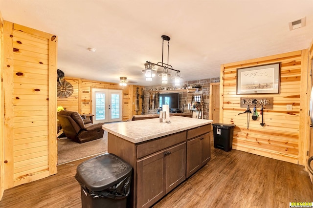 817 S 3rd St, Nebraska City, NE 68410 - kitchen featuring french doors, dark wood finished floors, wood walls, open floor plan, and a center island