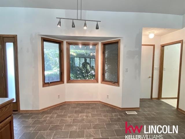2930 Drawbridge Ct, Lincoln, NE 68516 - unfurnished dining area featuring baseboards and track lighting