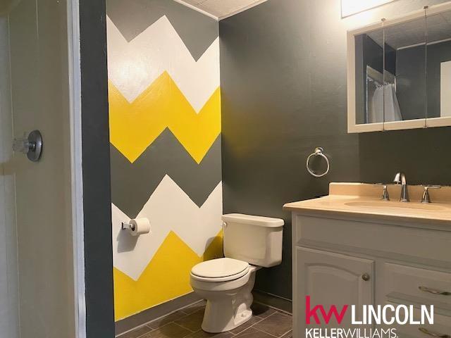 2930 Drawbridge Ct, Lincoln, NE 68516 - bathroom with vanity and a shower with curtain