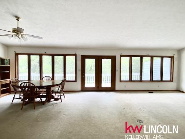 2930 Drawbridge Ct, Lincoln, NE 68516 - carpeted dining space featuring french doors and ceiling fan