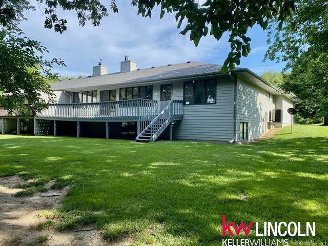 2930 Drawbridge Ct, Lincoln, NE 68516 - back of property with a lawn, a wooden deck, a chimney, and stairs
